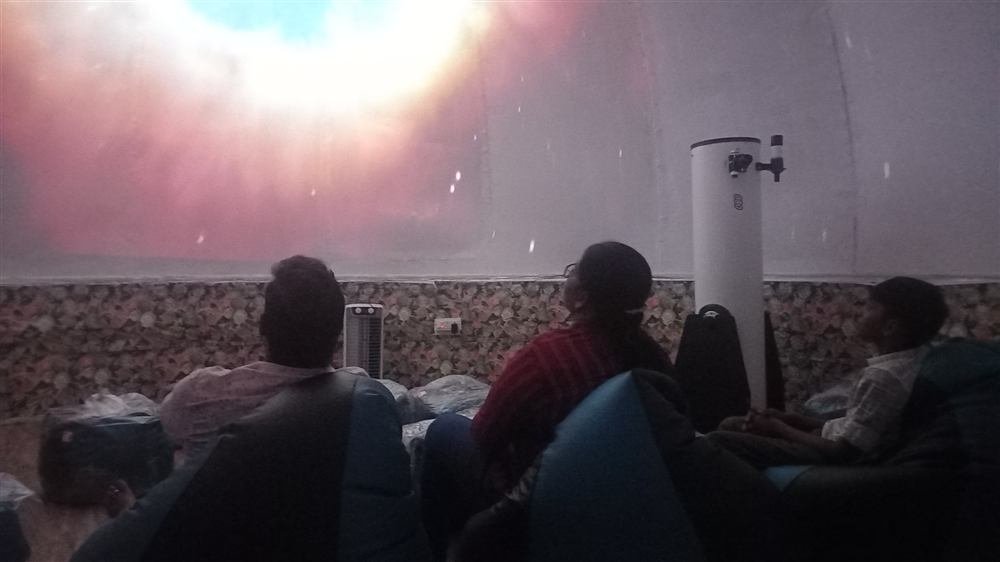 Audience inside a dome theatre watching a 360° show on the curved ceiling